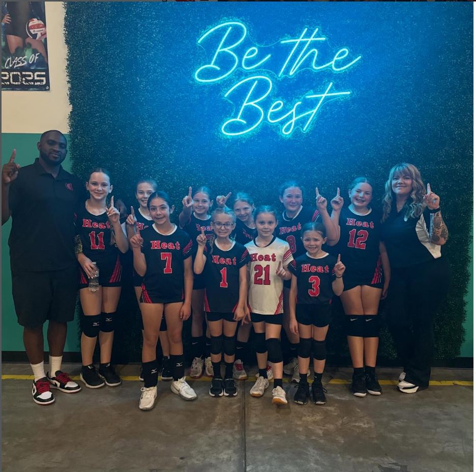 Nassau Heat 7–11 team beneath the Be the Best sign